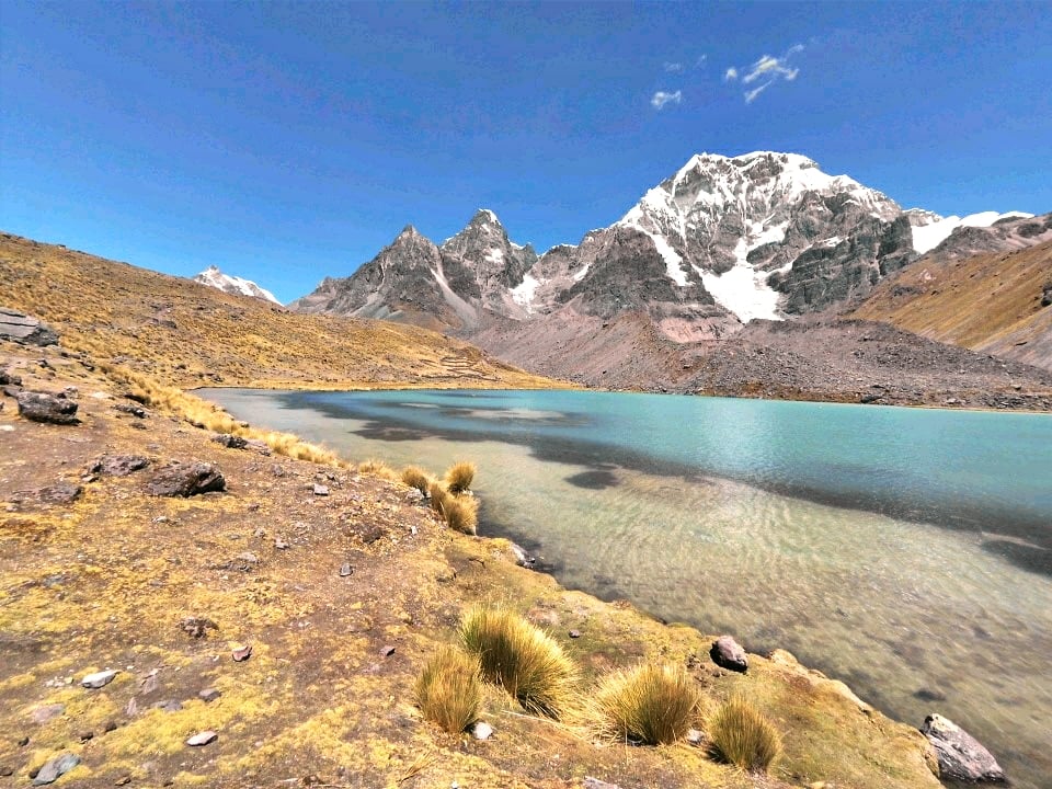 Shores of the crystal-clear lake Jatun Pucacocha in the Andes.