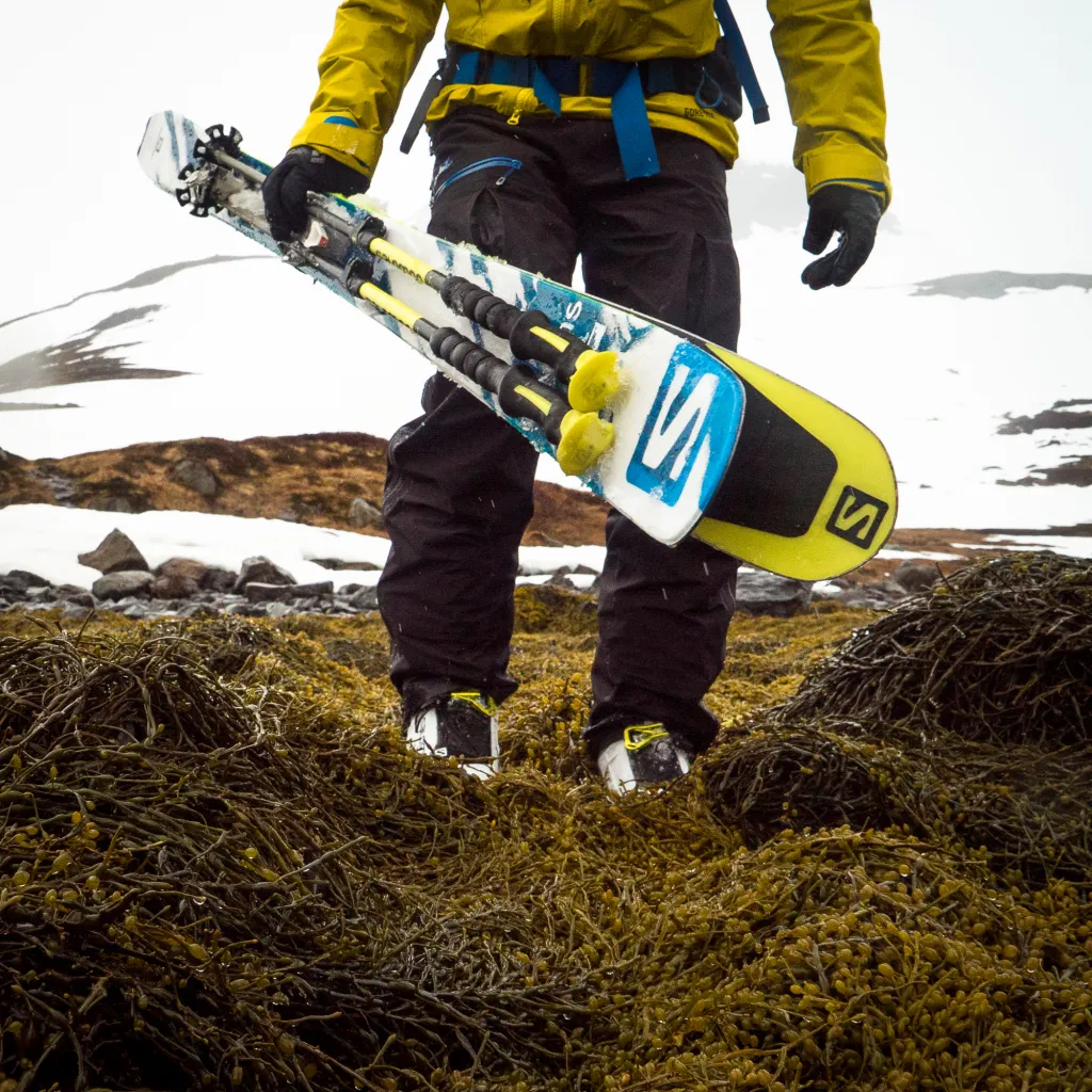 Skier after a ski run in the rain in Hornstrandir Nature Park, Iceland.