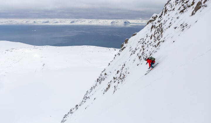 Skier on a steep slope in Svalbard