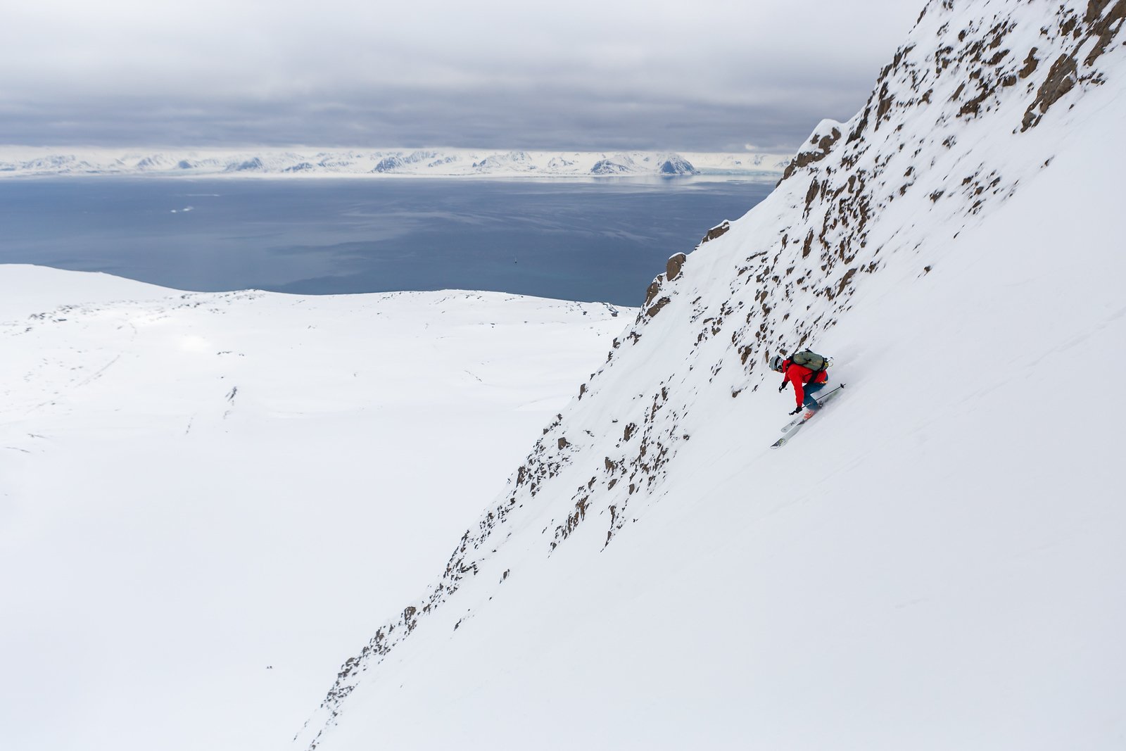 Skier on a steep slope in Svalbard