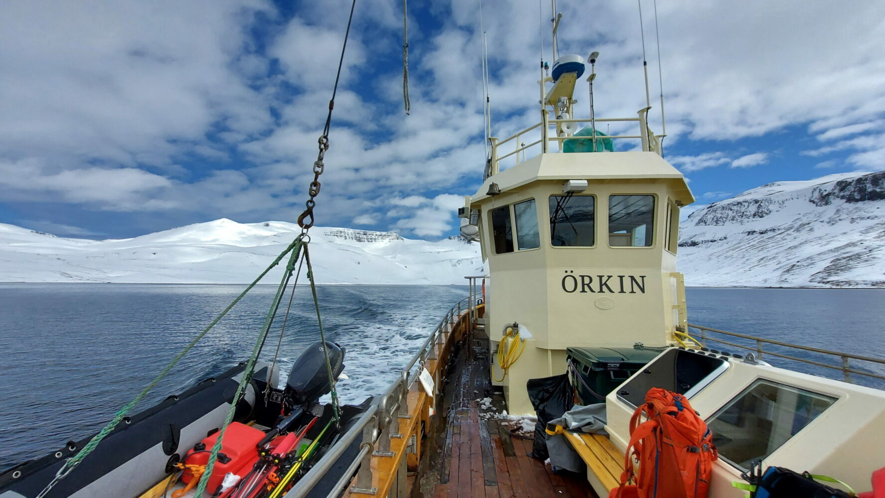 The Orkin sailboat gliding along the seas in the Westfjords, Norway.