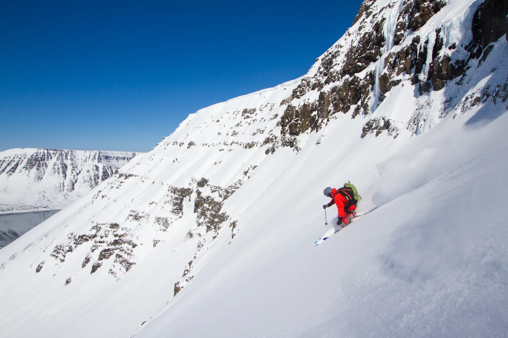 A skier on a summit-to-sea line in the Westfjords