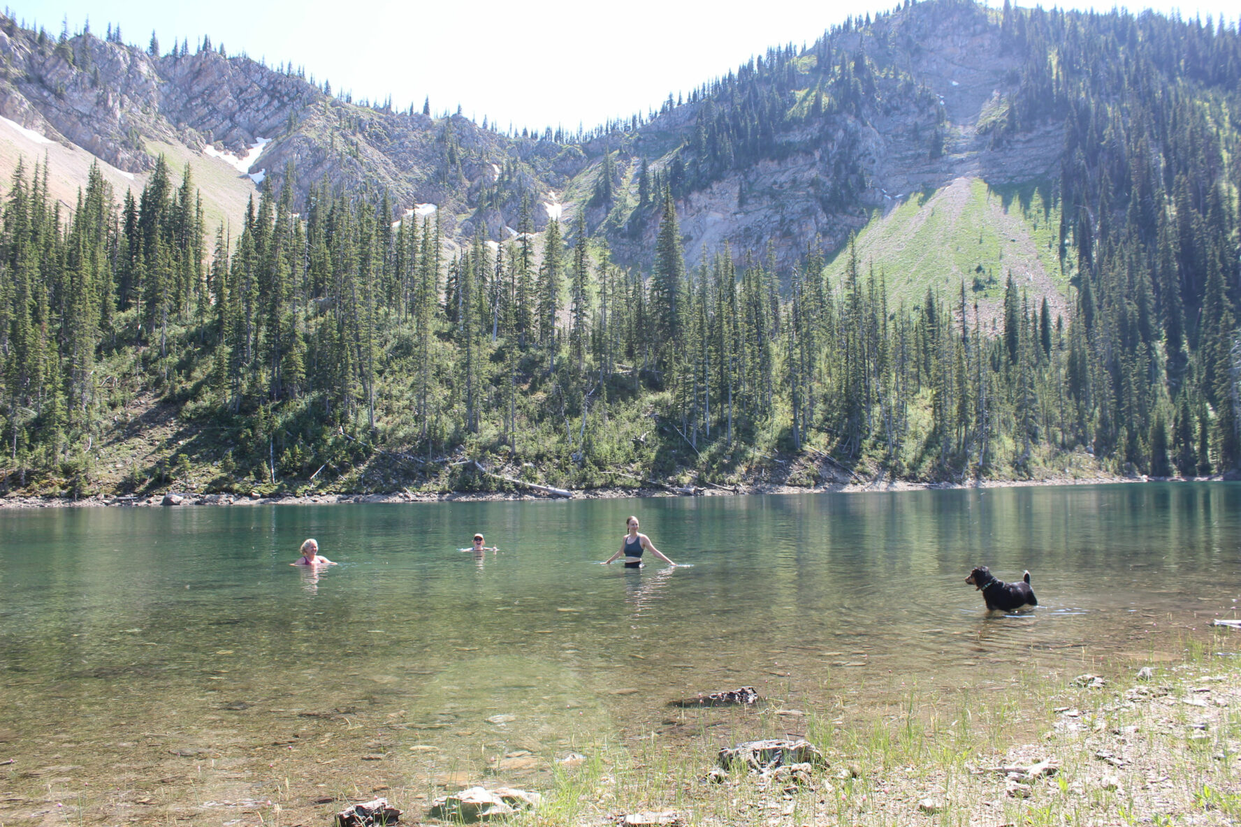 All-women backpacking. swimming in lake, Montana