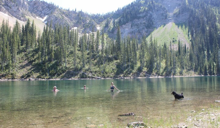 All-women backpacking. swimming in lake, Montana