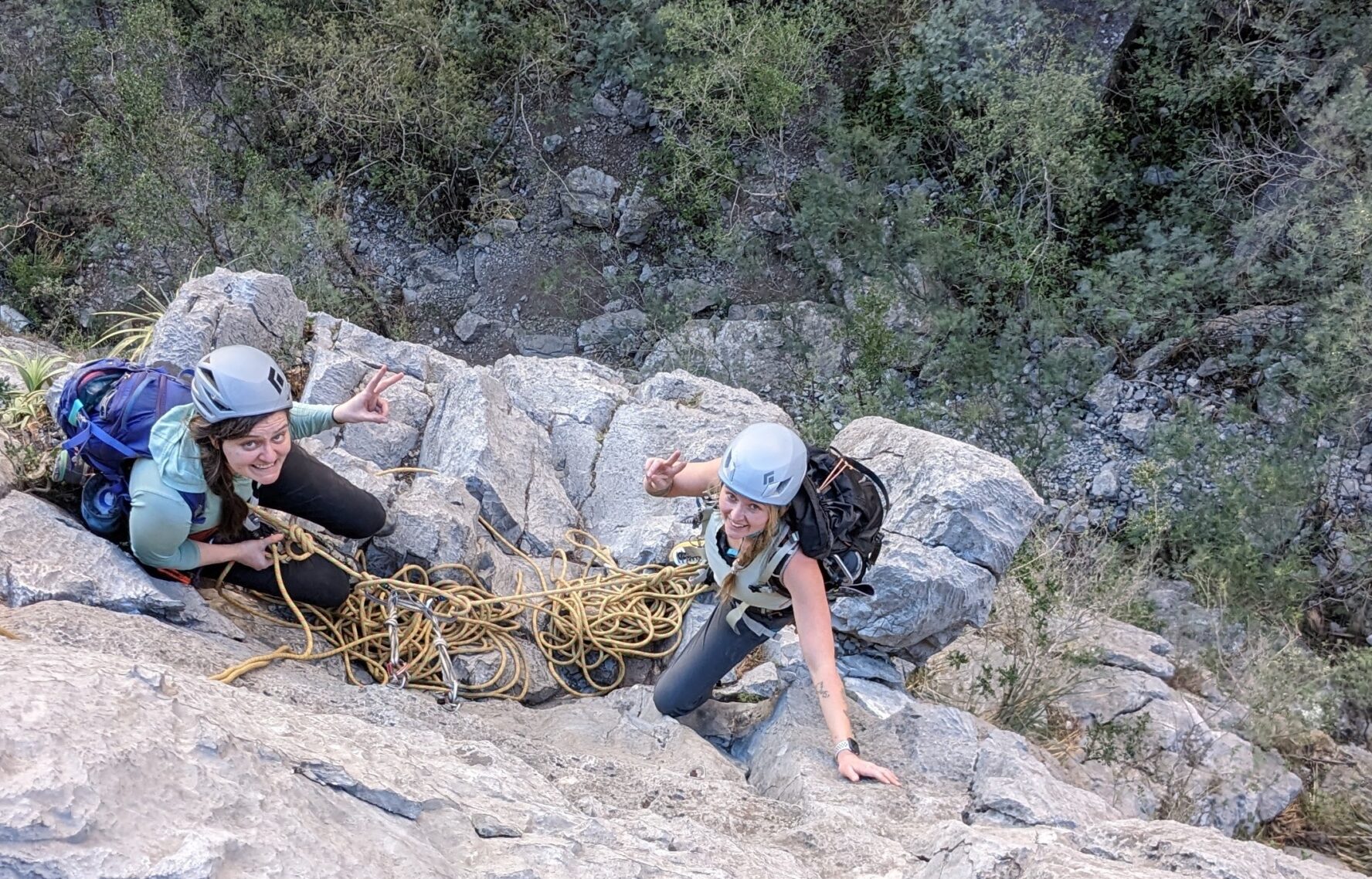 Two rock climbers preparing to start climbing another pitch during a multi-pitch climb at El Potrero Chico.