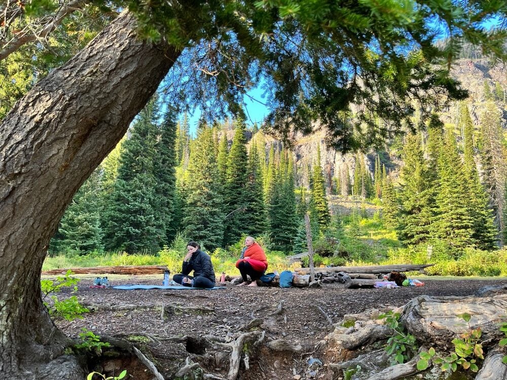 Backpackers sitting near the camp.