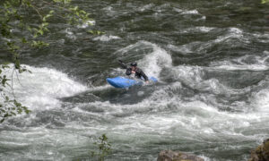 A kayaker working through a whitewater section on the Clackamas River.