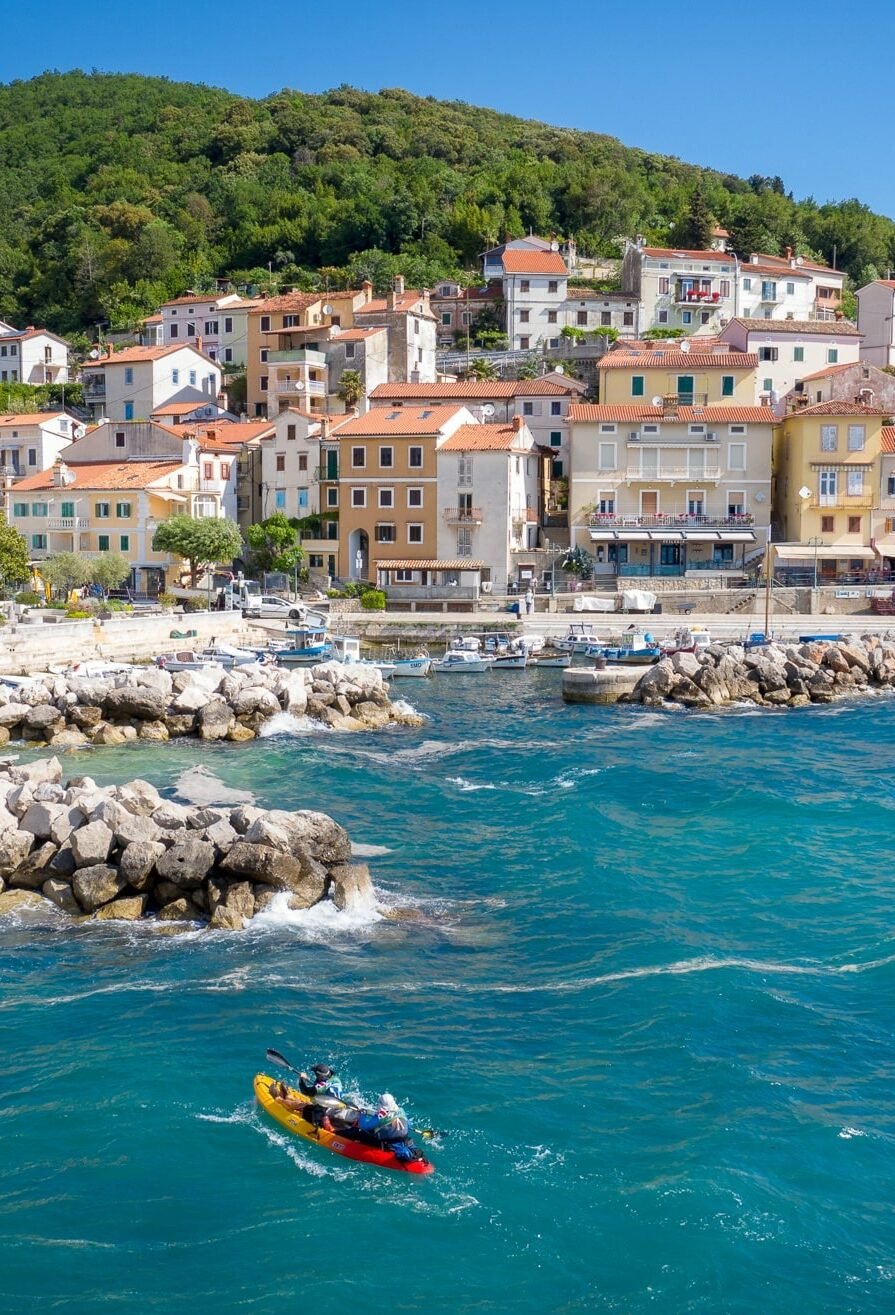 Sea kayaking near a city on Dalmatian coast