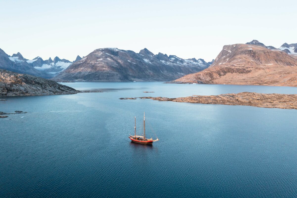A boat sailing through an endless expanse in East Greenland