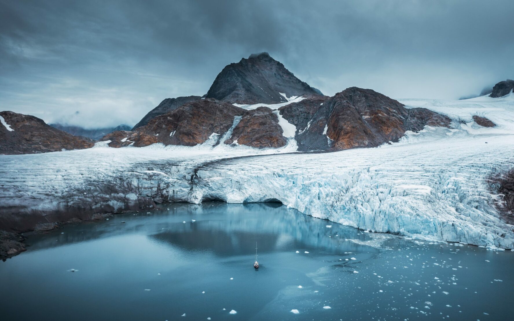 Sailboat gliding through an endless expanse in Greenland.