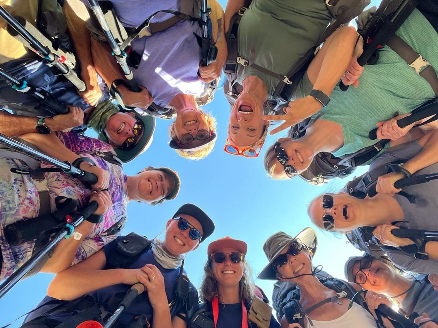 A picture of hikers smiling above the camera