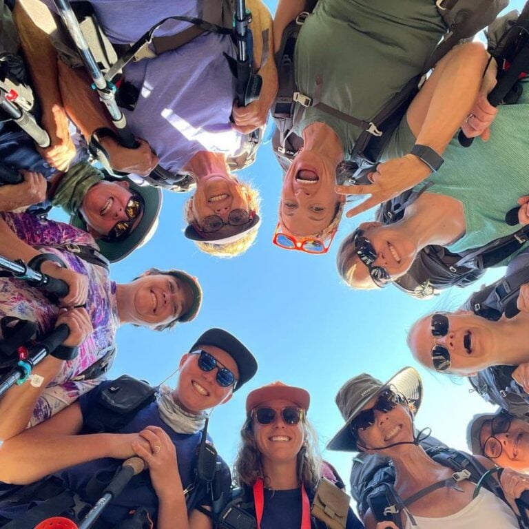 A picture of hikers smiling above the camera