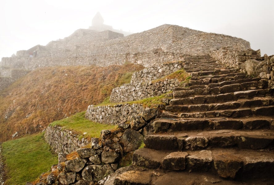  Steep stone steps, next to terraced plots, lead up to Machu Picchu.