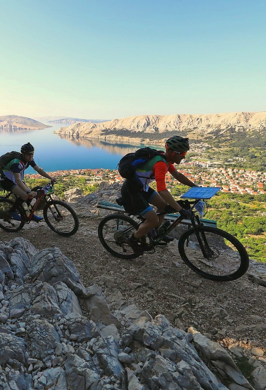 Adveture racers, navigator in the front with a map, and Dalmatian coast in the back