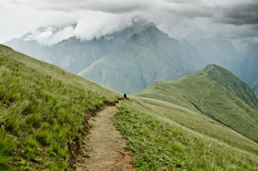 A lone hiker walking in the Sacred Valley of Peru.