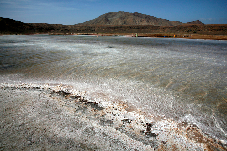 'Salinas' : Salt pans of Pedra de Lume, Inside the crater of a long extinct volcano, Midway up the east coast of Island of Sal, Cape Verde (Cabo Verde), off the West coast of Senegal (West Africa). Cape Verde, an Island Republic in the Atlantic. Formerly an overseas territory of Portugal, gained Independence on July 5th, 1975. 434,812 inhabitants (2000 census). Capital: Praia, Santiago Island. Sal Surface : 216 km2. 30km long, 12km large. Approx. 14,792 inhabitants. One of the 3 sandy eastern islands of the archipelago. (Ten islands, Nine inhabited). Also the flattest and the driest of all Cape Verde islands. No ground water founded. All water supplies are brought by boat on containers from Praia or elsewhere. Sal Island has been discovered circa 1460 by Portuguese and named after the Salt Laguna founded in the South and at 'Pedra de Lume', the crater of an extinct volcano. Salt export business exploited from early 19th century attracted many newcomers and brought a relative prosperity till its decline in the first half of the 20th century. By 1985, the salinas ceased all operations. In 1990, there were still 700 residents in Pedra de Lume. Unfortunately, the economy of the town only offers a handful of job opportunities, so the rest had to migrate to other parts of Sal or abroad. The site has now been turned into a resort.