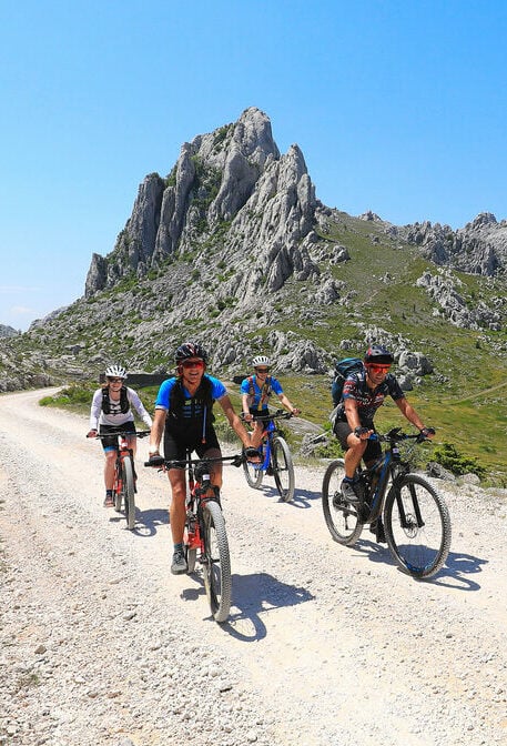 Mountain bikers on a macadam trail near Tulove Grede