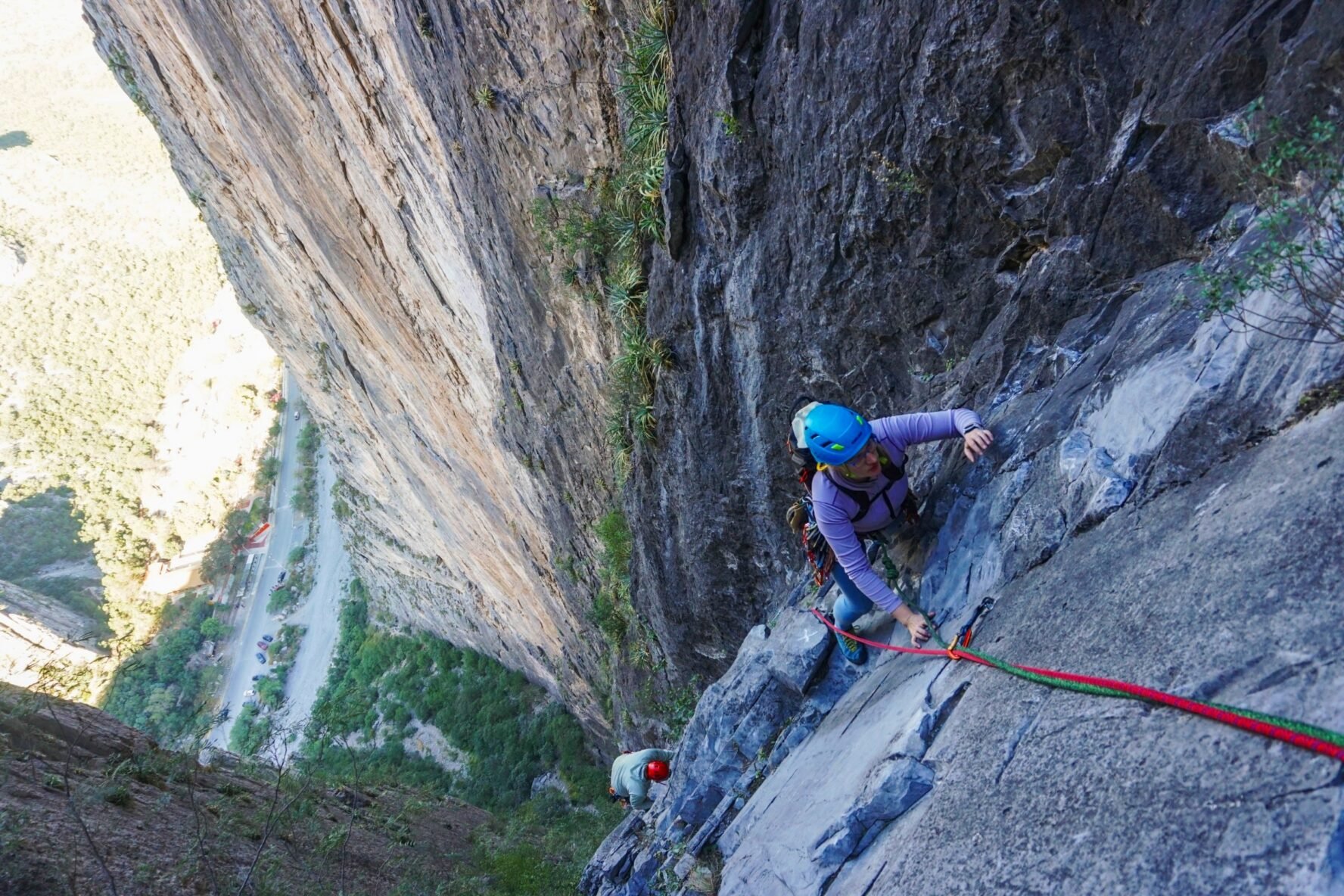Two climbers scaling a vertical wall on a multi-pitch climb at El Potrero Chico.