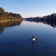 Kayker on the calm, glassy waters of the Willamette River.