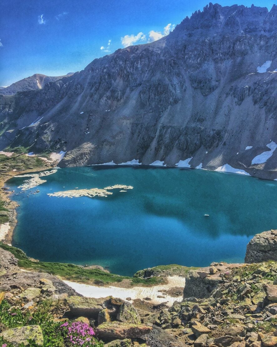 Blue Lake sits nestled between peaks and alpine meadows. 