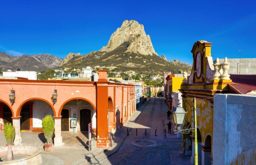 The Peña de Bernal monolith overlooking a Mexican city.