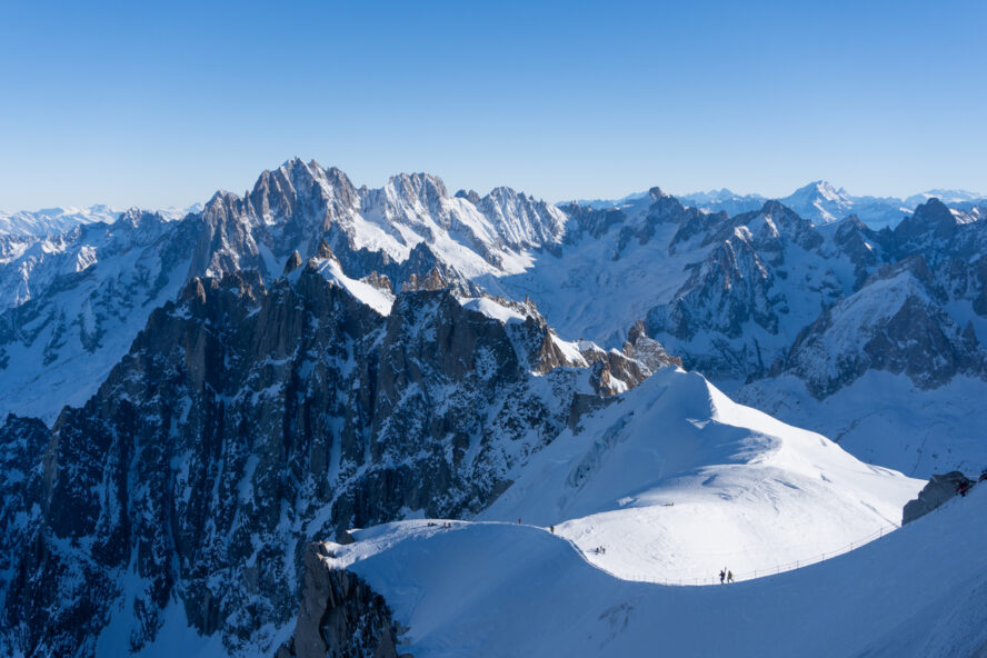 Skiers traversing a ridge in the French Alps near Chamonix Mont Blanc.