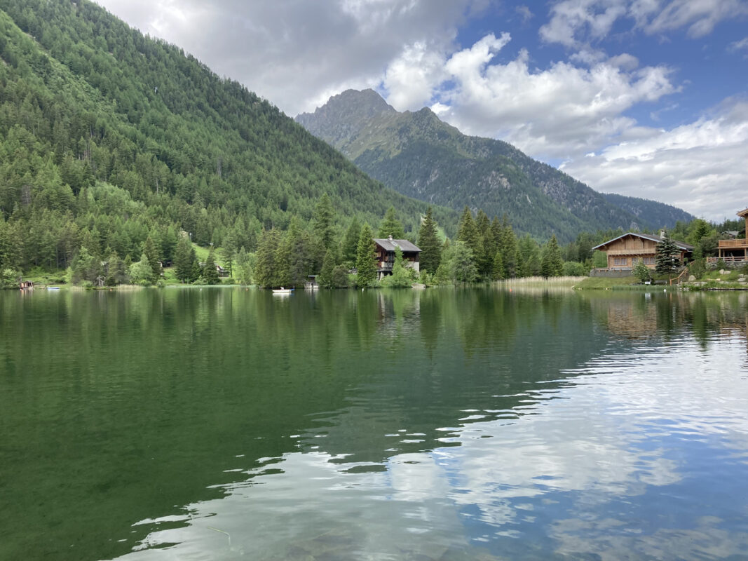 Vedute of Champex, an Alpine village in Switzerland nestled beside a lake.