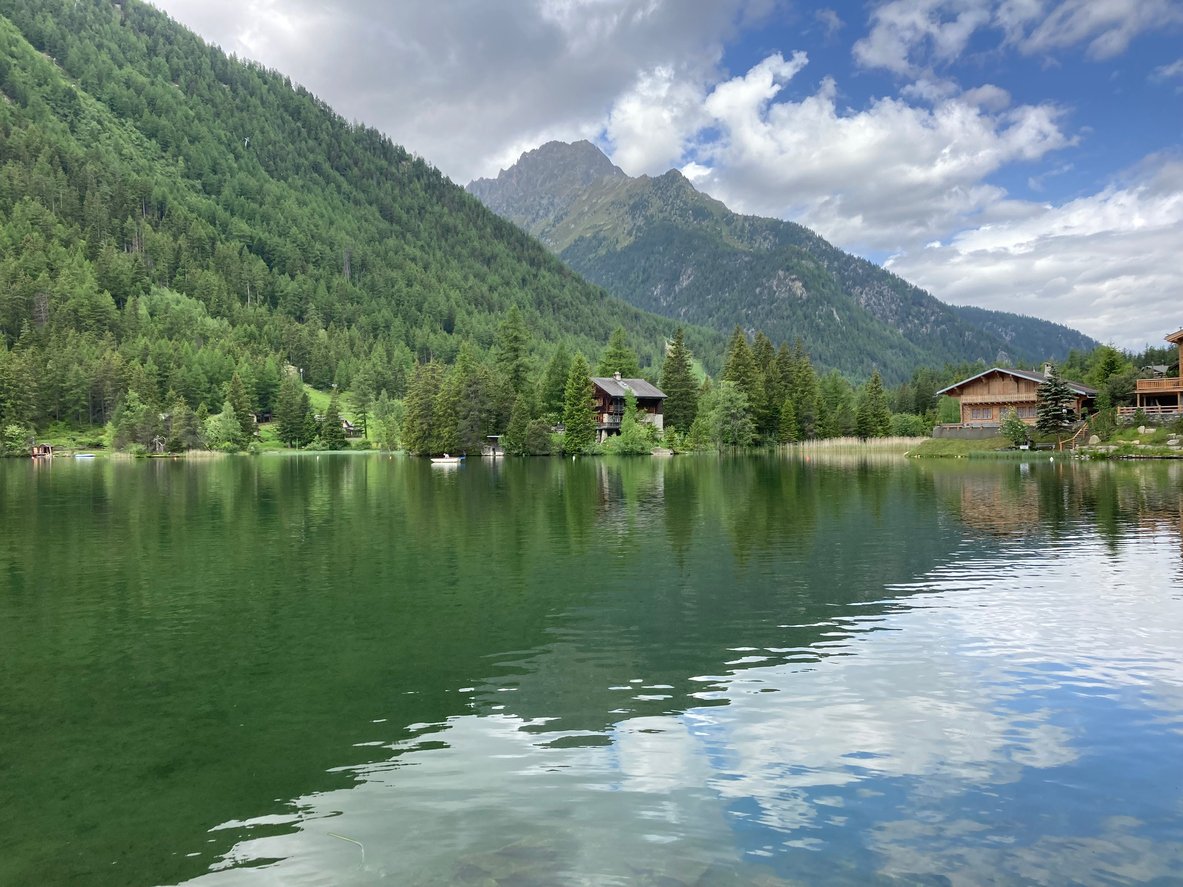 Vedute of Champex, an Alpine village in Switzerland nestled beside a lake.
