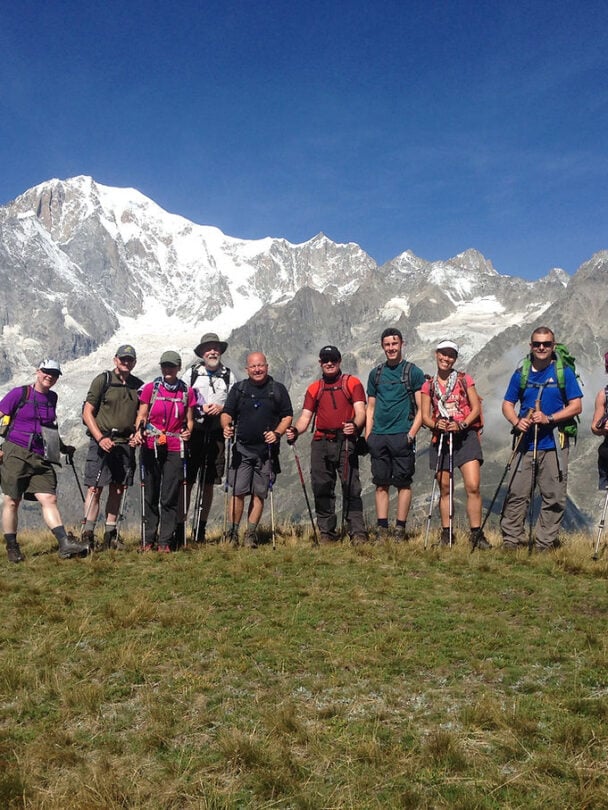 Group of happy hikers on TMB highlights