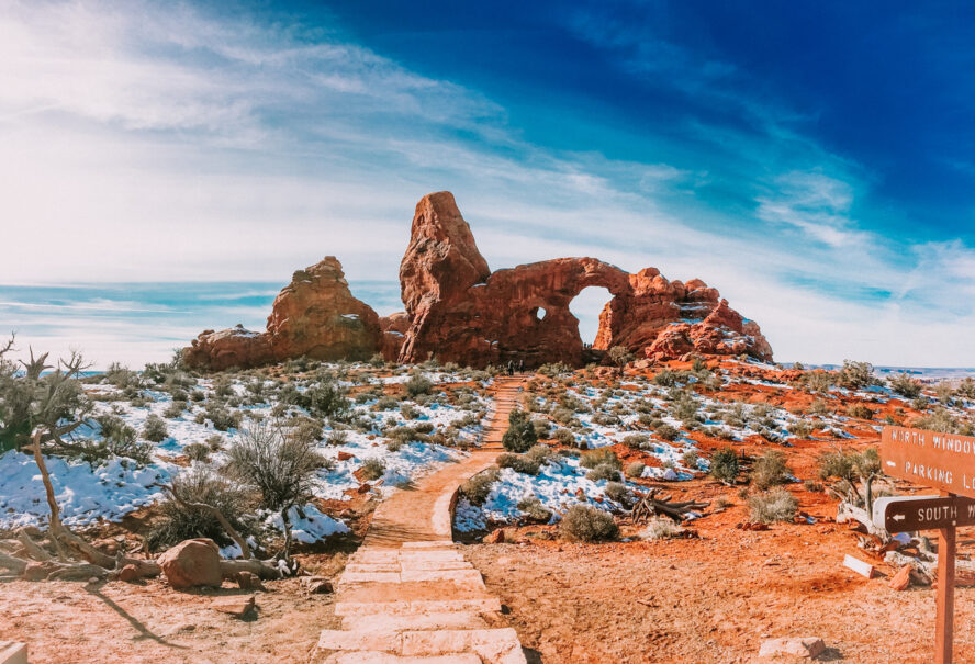 The iconic Turret Arch in Arches National Park, Utah, under a light snow cover.