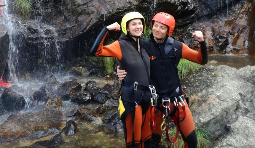 Two canyoneers posing for a picture among the gorgeous river scenery encountered while on a canyoning trip near Madrid.