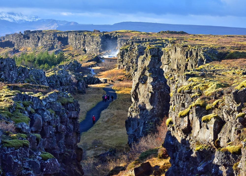 Path among tectonic plates to Oxararfoss waterfall in Thingvellir National Park