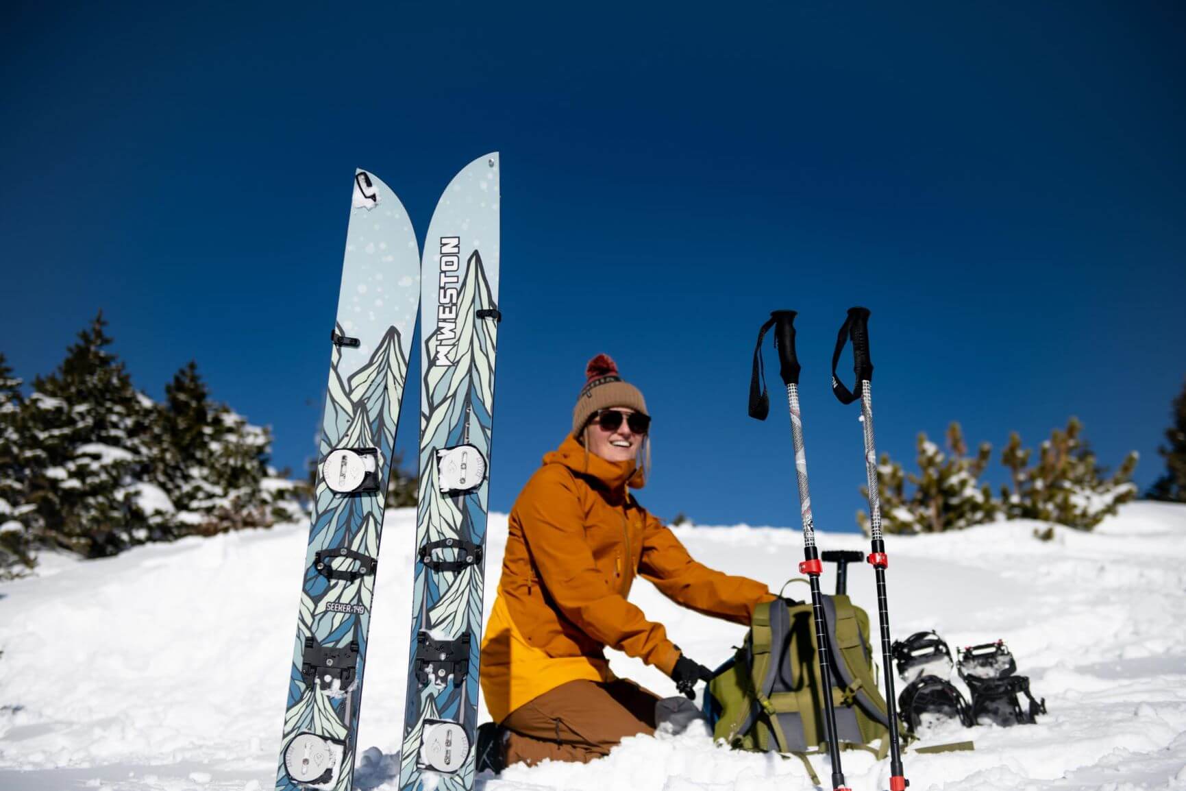 A backcountry skier photograšhed with her splitboard relaxing during a field learning session during the AIARE 1 course in the Summit County.