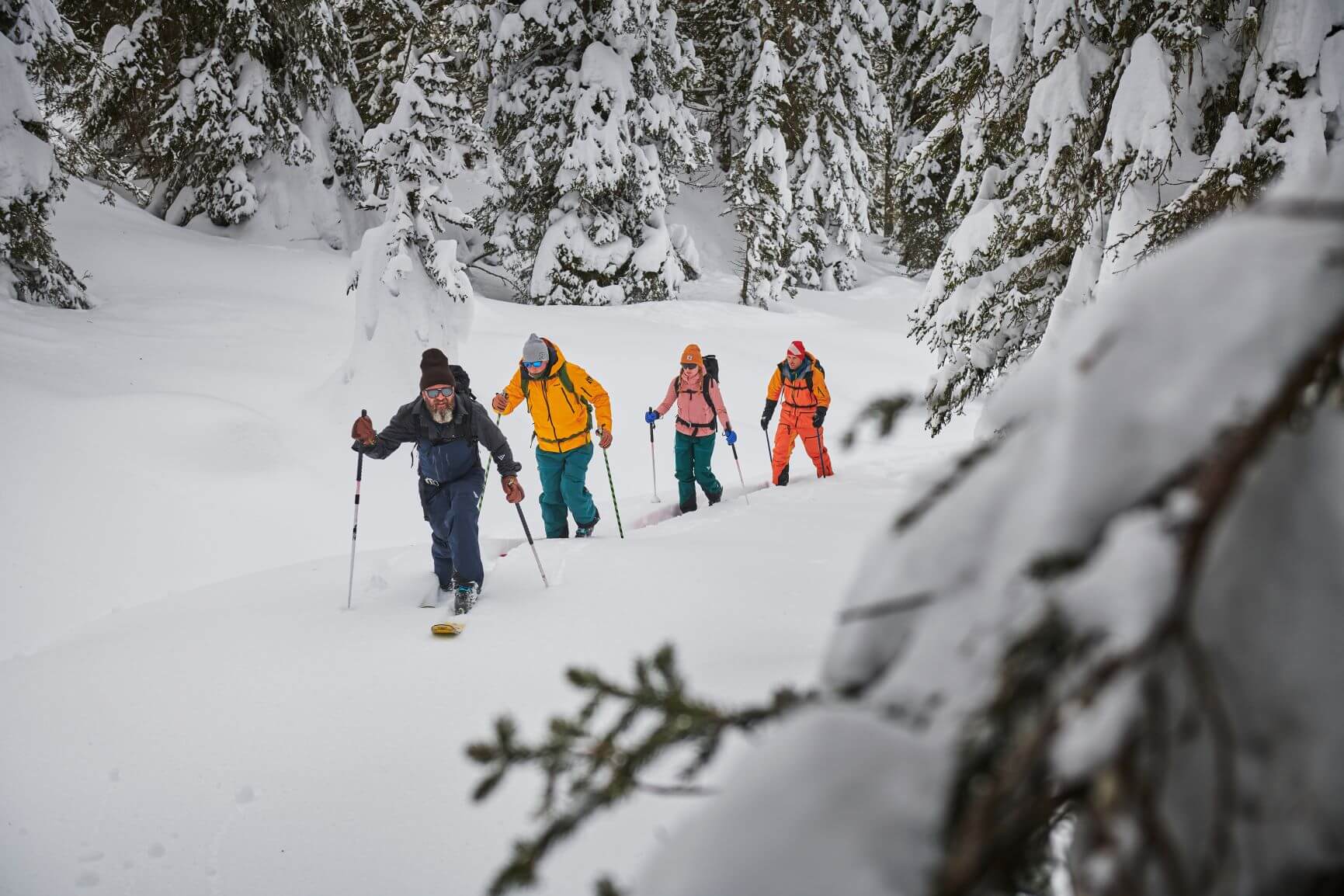 A group of backcountry skiers traversing a trail on their skis in the Summit County, Colorado.