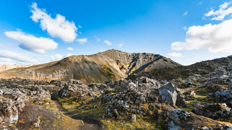 Bláhnúkur Mountain with rocky outcroppings and boulders in the foreground.