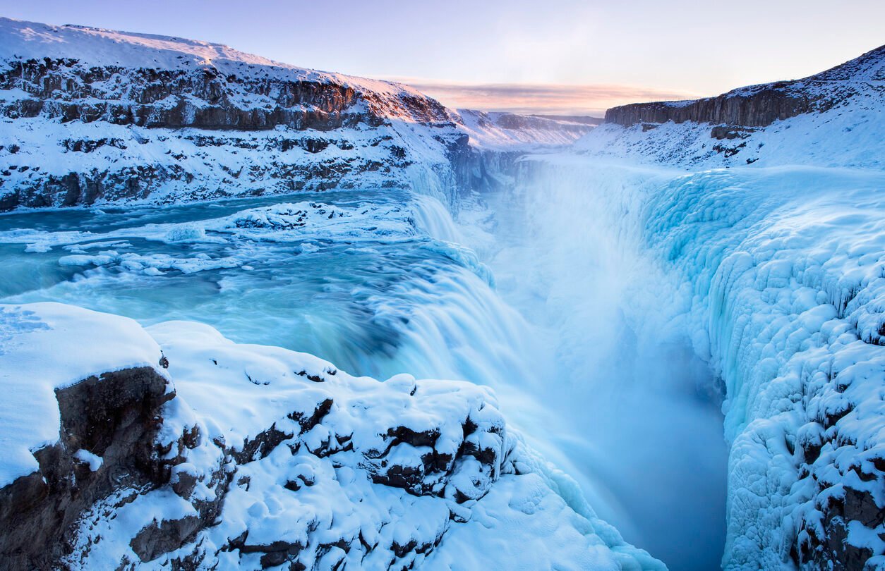 Frozen Gullfoss Falls in Iceland in winter at sunset.