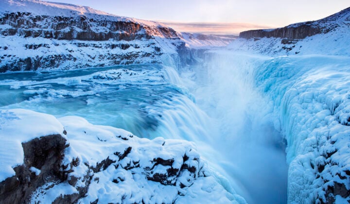 Frozen Gullfoss Falls in Iceland in winter at sunset.
