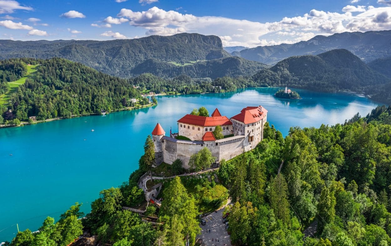 Aerial view of Lake Bled overlooked by a castle.