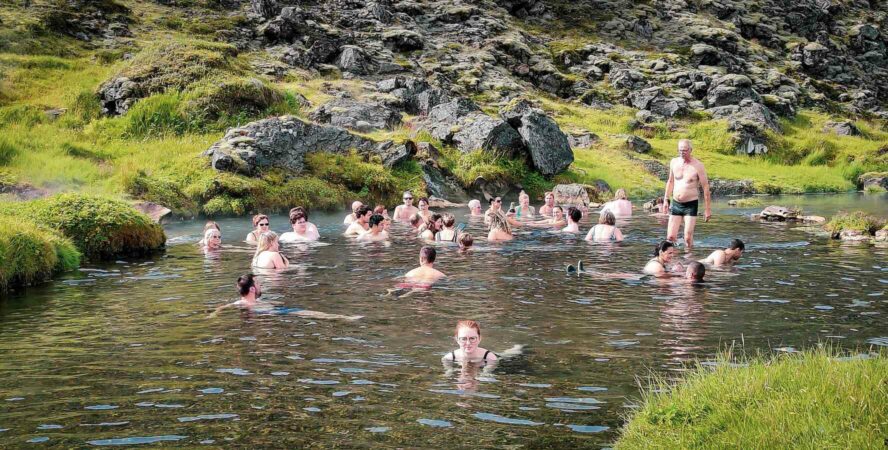 Group enjoying the natural hot springs of Landmannalaugar.