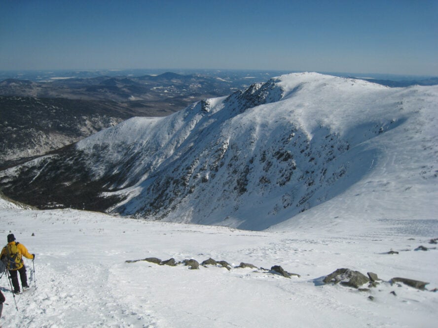  backcountry skier hiking down to Tuckerman Ravine on Mount Washington