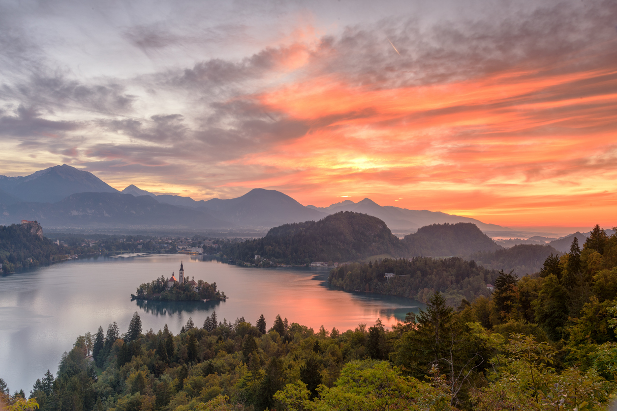 View of Lake Bled in Slovenia’s Julian Alps from the Ojstrica viewpoint during sunrise.