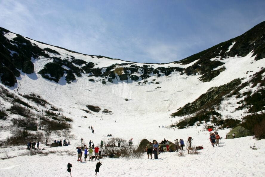 Groups of people gathering at the base of Tuckerman Ravine