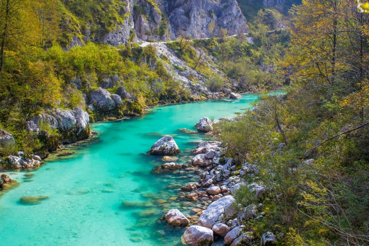 Turquoise Soča river seen during hiking holidays in Slovenia’s Julian Alps.