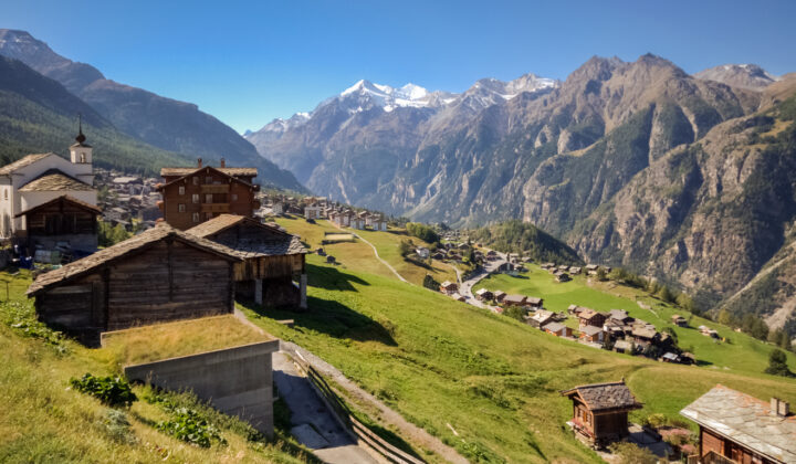 Idyllic Swiss Alpine village of Grächen, surrounded by Alpine ridges and meadows.