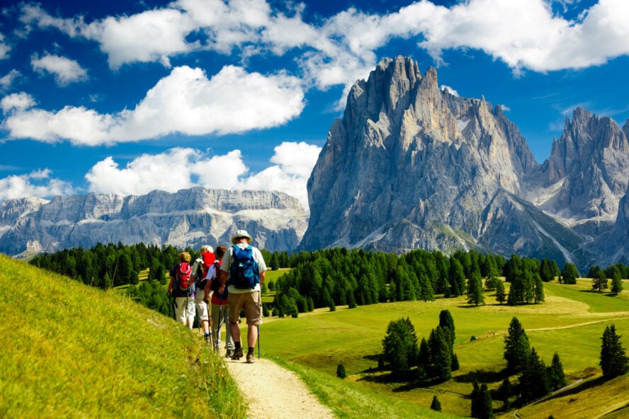 Group of hikers on a trail under the Dolomites