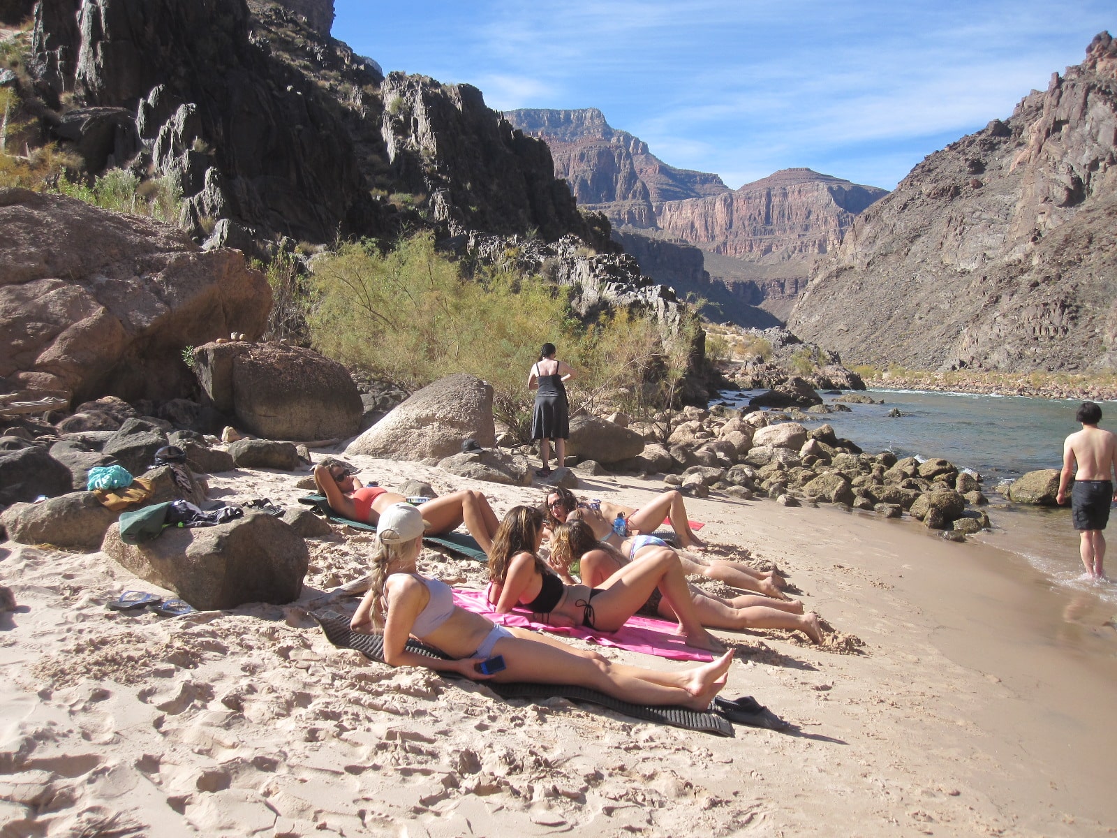 Hikers swimming on the Colorado River.
