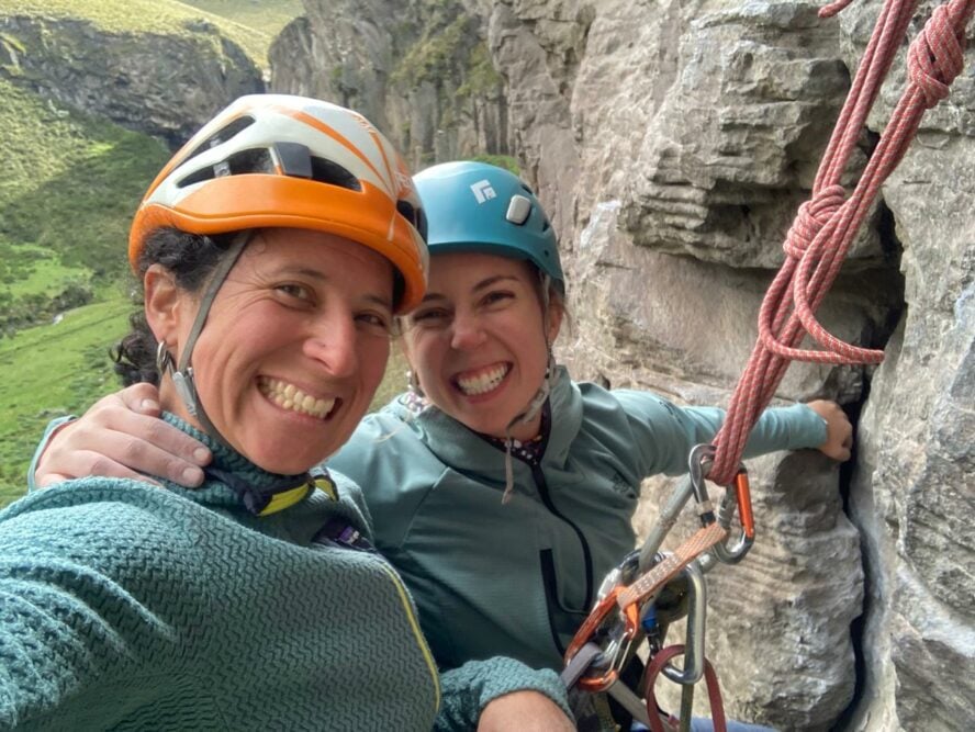 Juliana Garcia (left) and the author Avery Stolte (right) sit at a rock anchor in El Acantilado, Ecuador. 