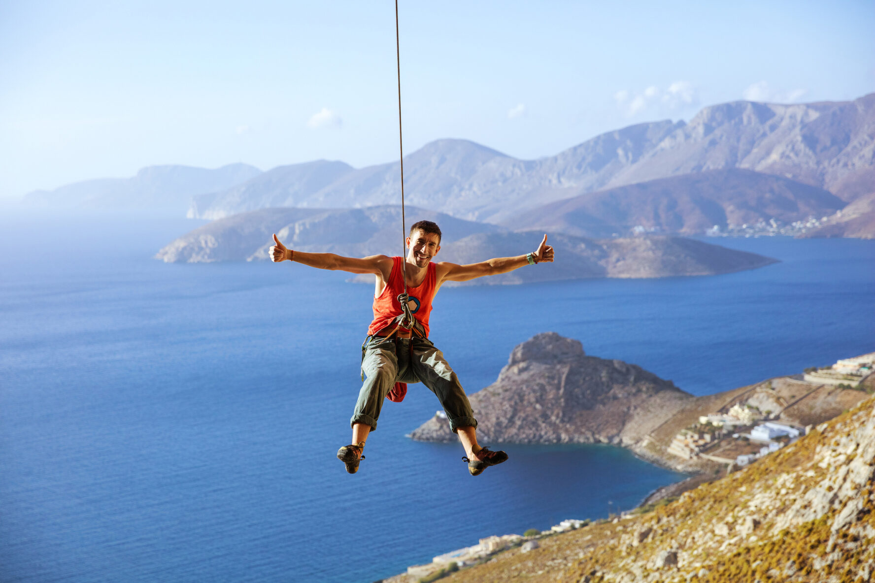 A climber celebrating a successful climb in Kalymnos, Greece.