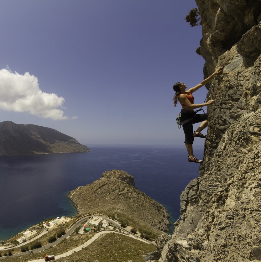 A woman climber and a vista in Kalymnos, Greece