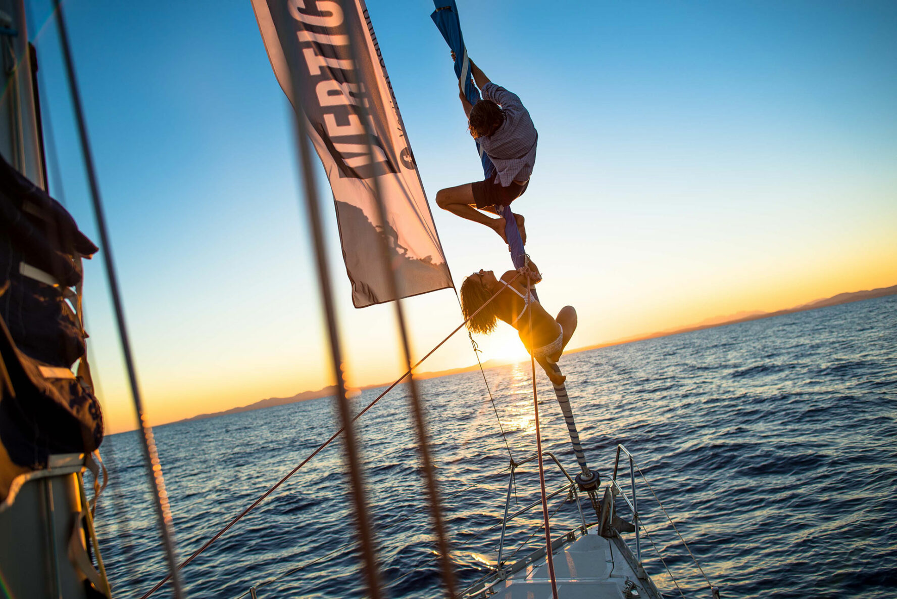 Rock climbers on a sailboat
